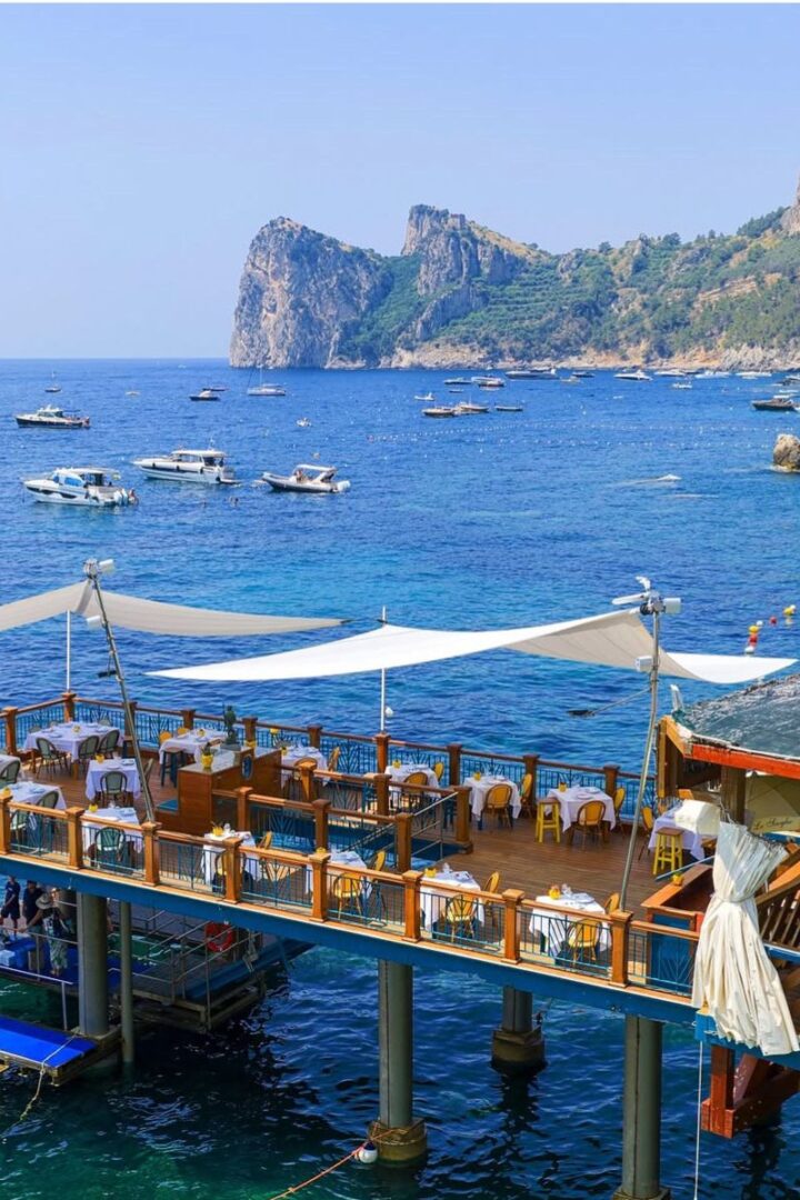 overhead shot of a restaurant on a dock over the sea