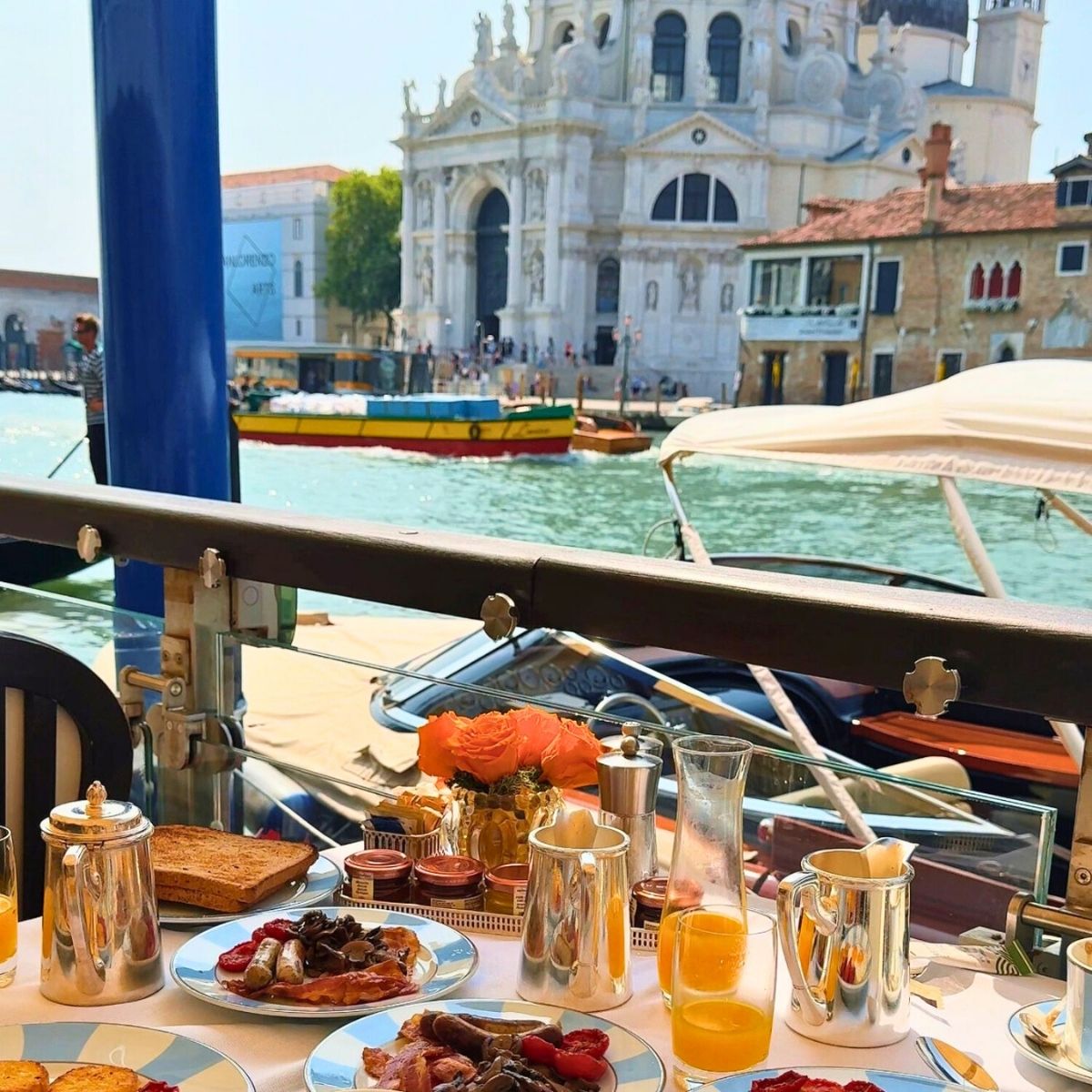 table covered with breakfast foods overlooking the Grand Canal in Venice