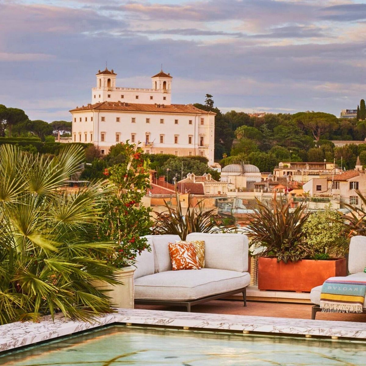 rooftop patio in Rome with a white building in the background