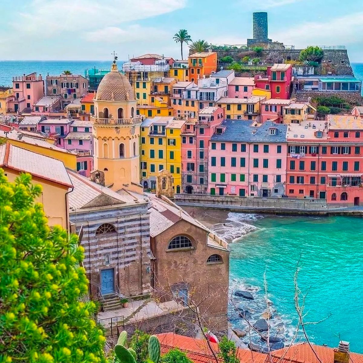 overhead shot of the sea and colorful pastel buildings in Cinque Terre