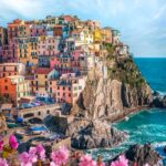 overhead shot of cliffside town with colorful pastel buildings in Cinque Terre