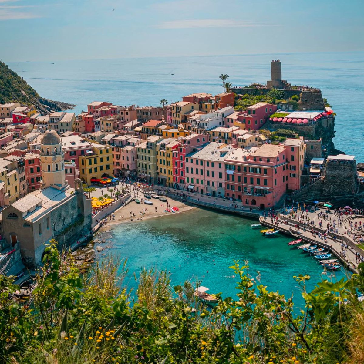 overhead shot of beach and colorful pastel buildings in Cinque Terre