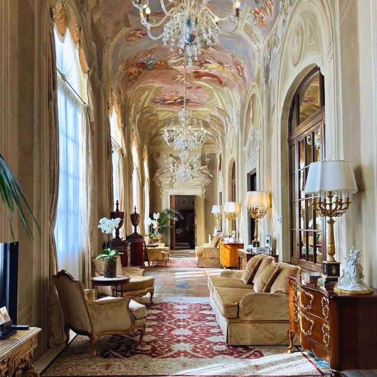 hallway with arches and painting on the ceilings