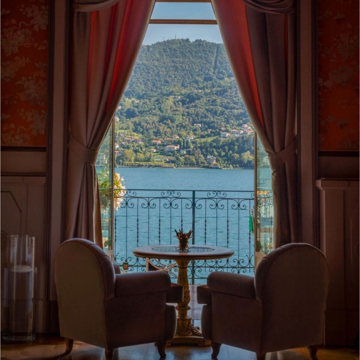 two arm chairs looking out on lake como