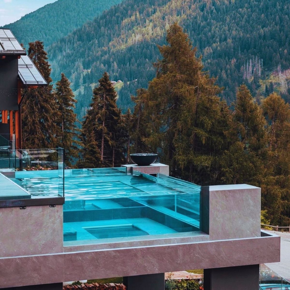 pool in the mountains with pine trees next to it