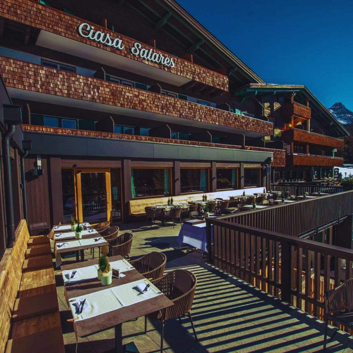 old ski lodge with deck and table and chairs