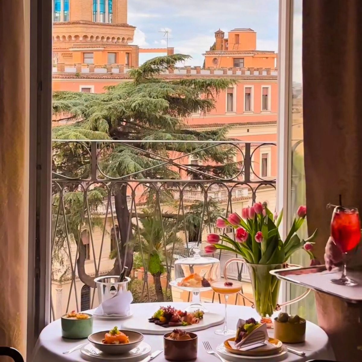 breakfast table overlooking pink rome building