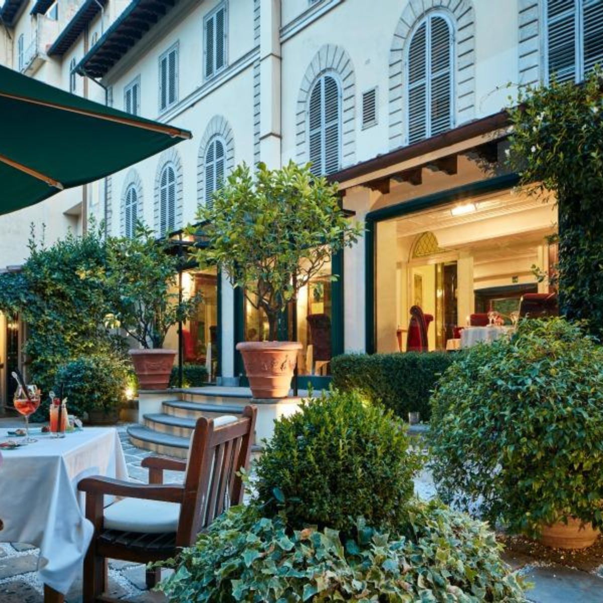 outdoor table on a patio with a stone building in the background