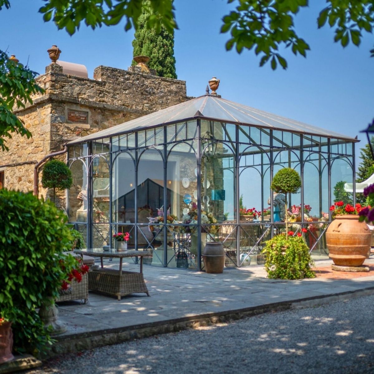 glasshouse with flowers and greenery in tuscany