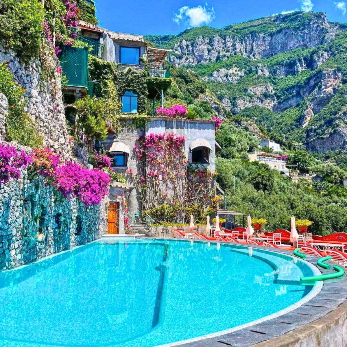 swimming pool in a cliff surrounded with pink flowers