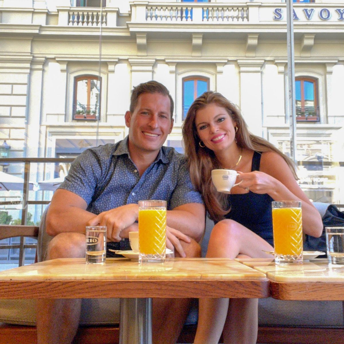 man and woman drinking coffee at a cafe