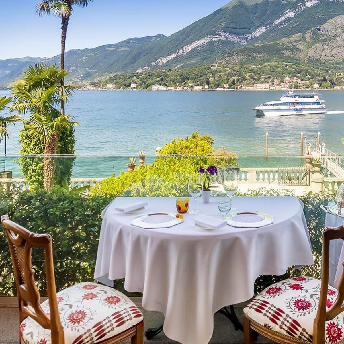 white table cloth table and chairs overlooking lake como