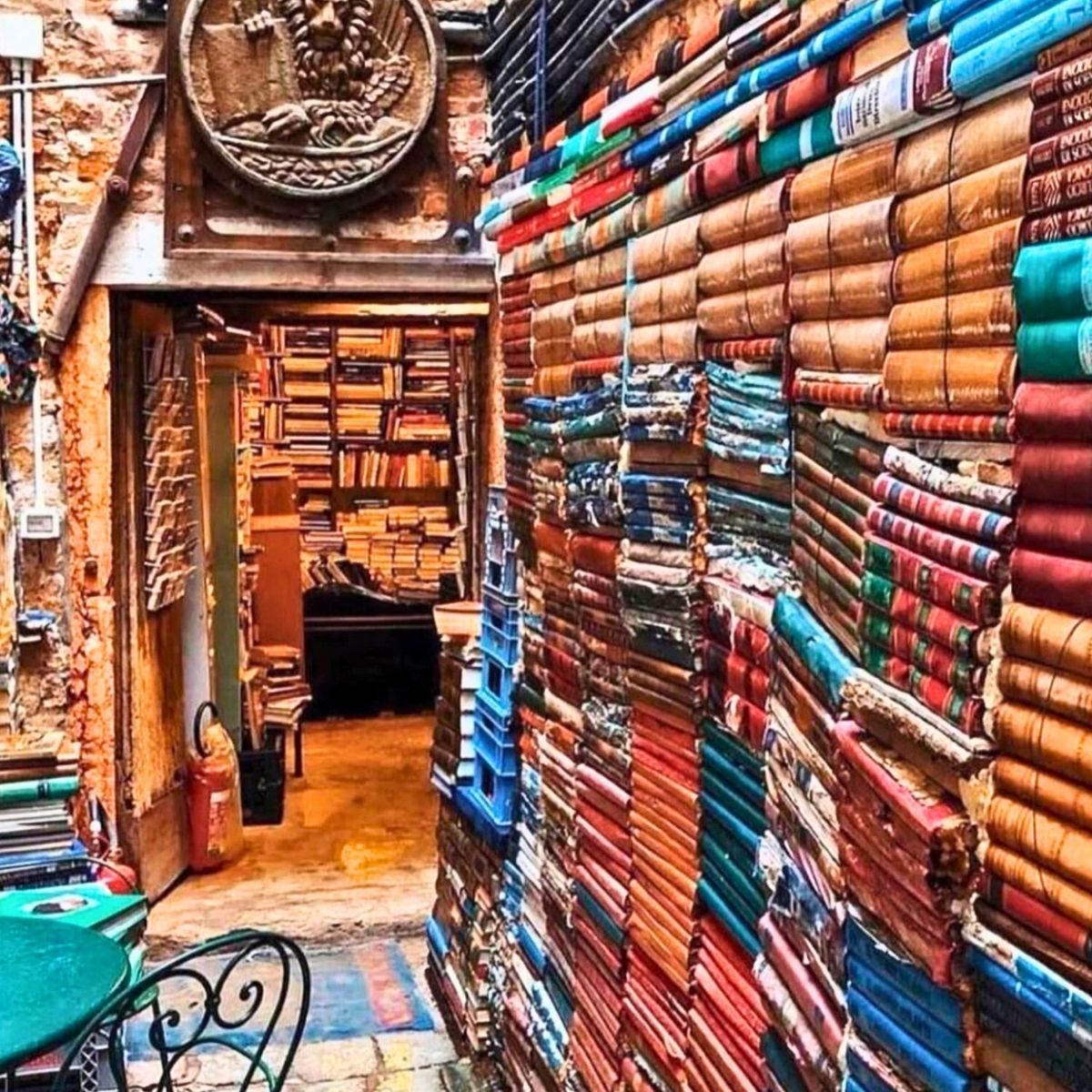 Libreria Acqua Alta with stacks of colorful books in the courtyard