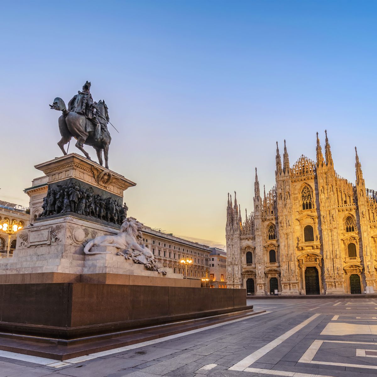statue of a horse with milan duomo in the background