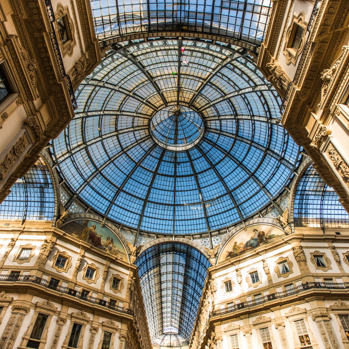 glass circular ceiling with blue sky above it