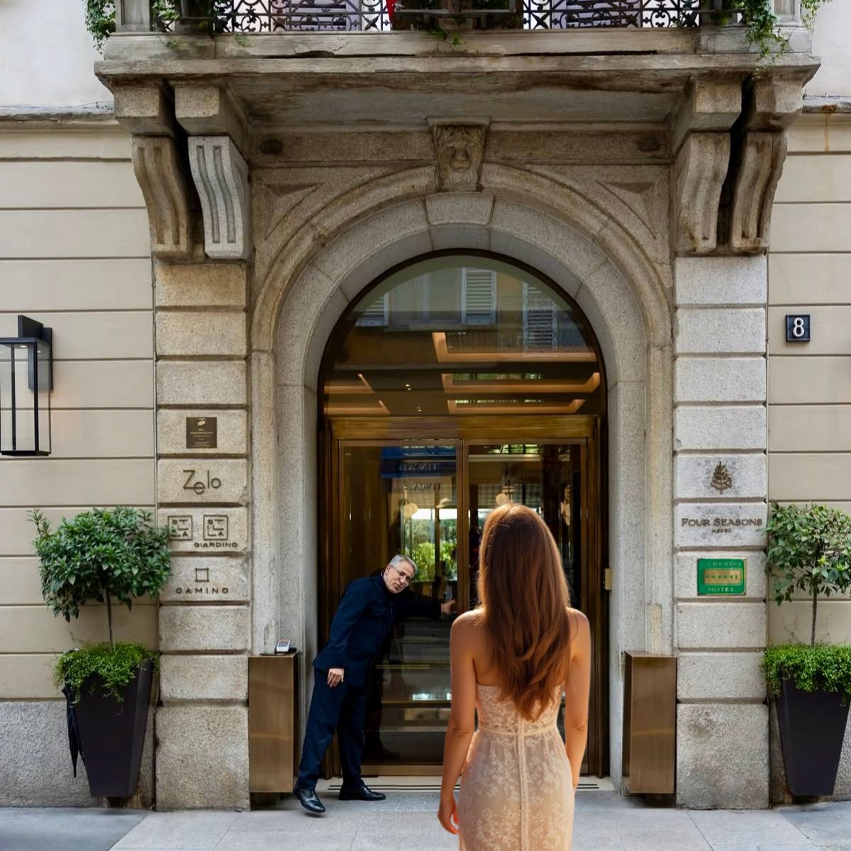 woman in lace dress walking into four seasons milan hotel