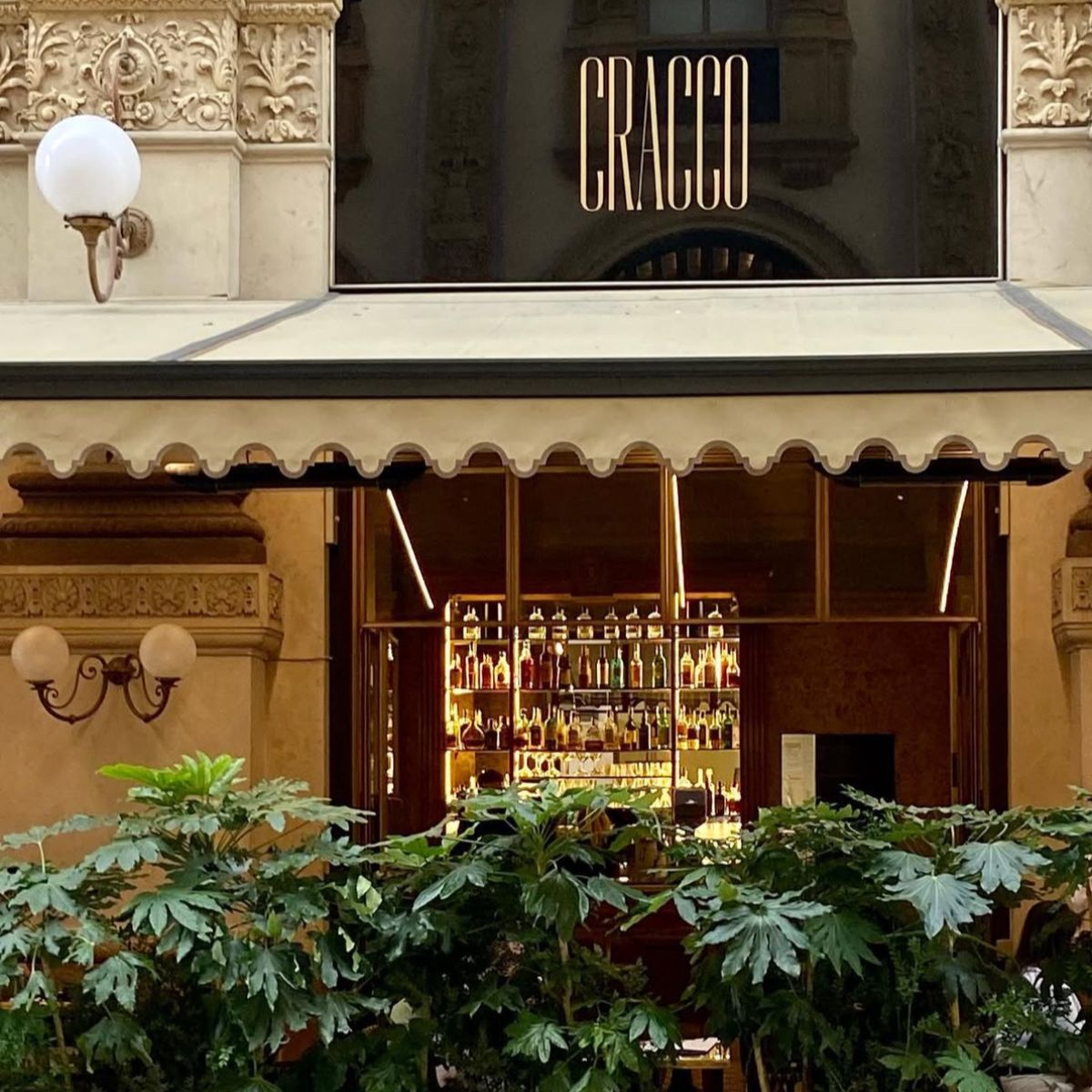 outside of a restaurant with a cream awning