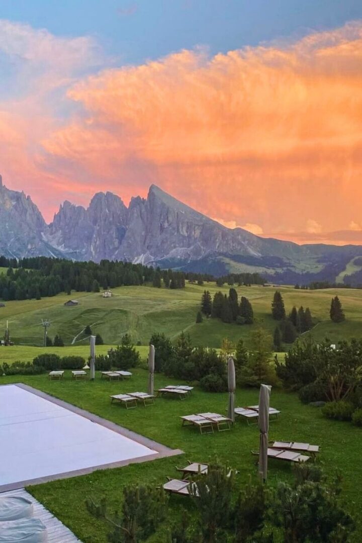 pool in the mountains with a sunset sky