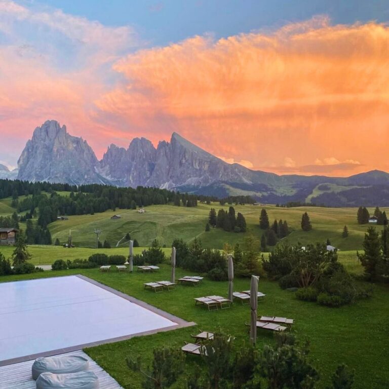 pool in the mountains with a sunset sky