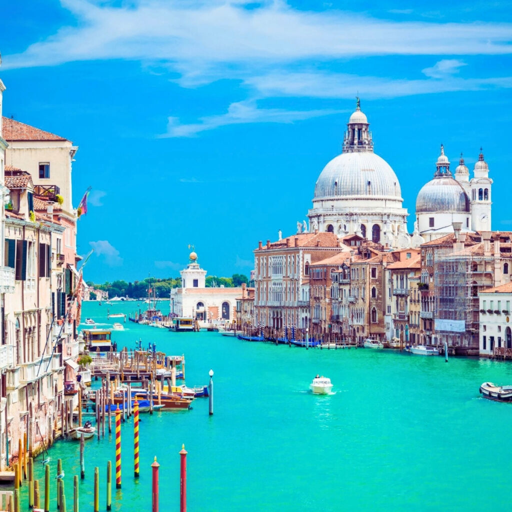 sunny day in venice with boats cruising the Grand Canal