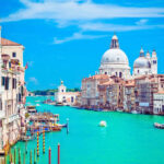 sunny day in venice with boats cruising the Grand Canal