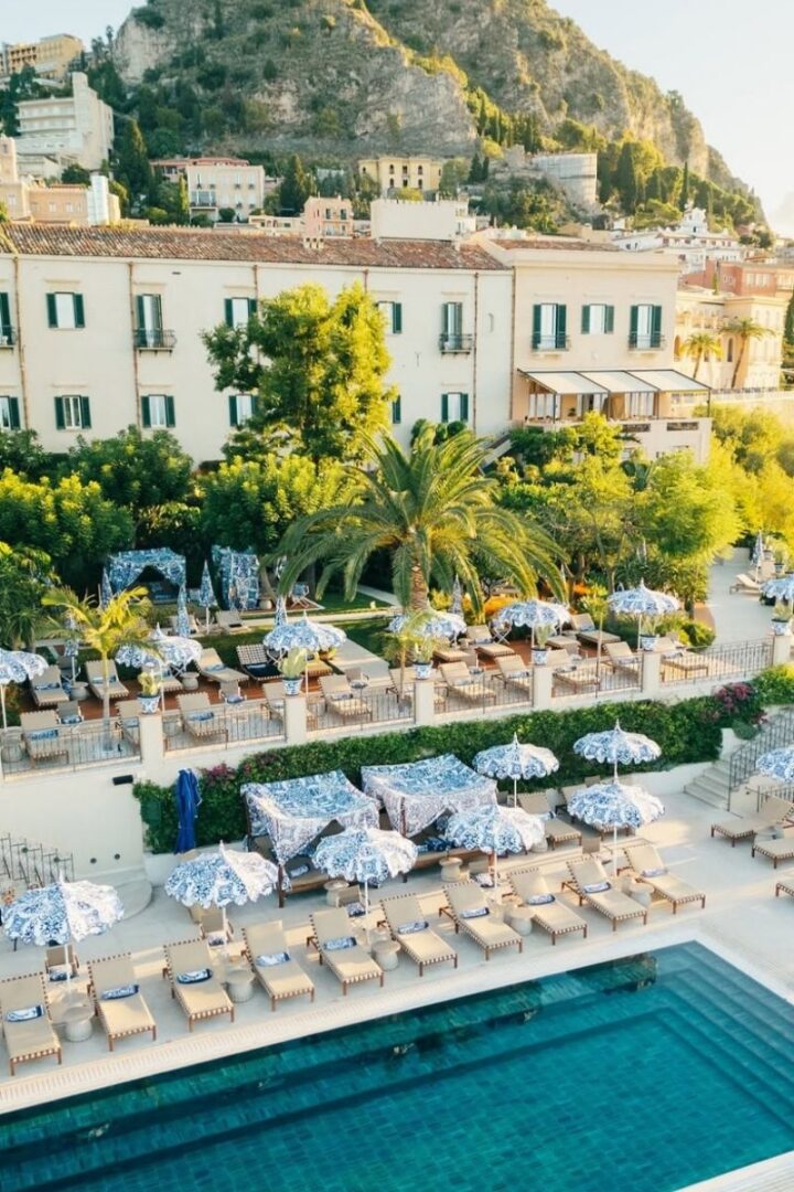 villa with green shutters on the taormina cliffside with infinity pool
