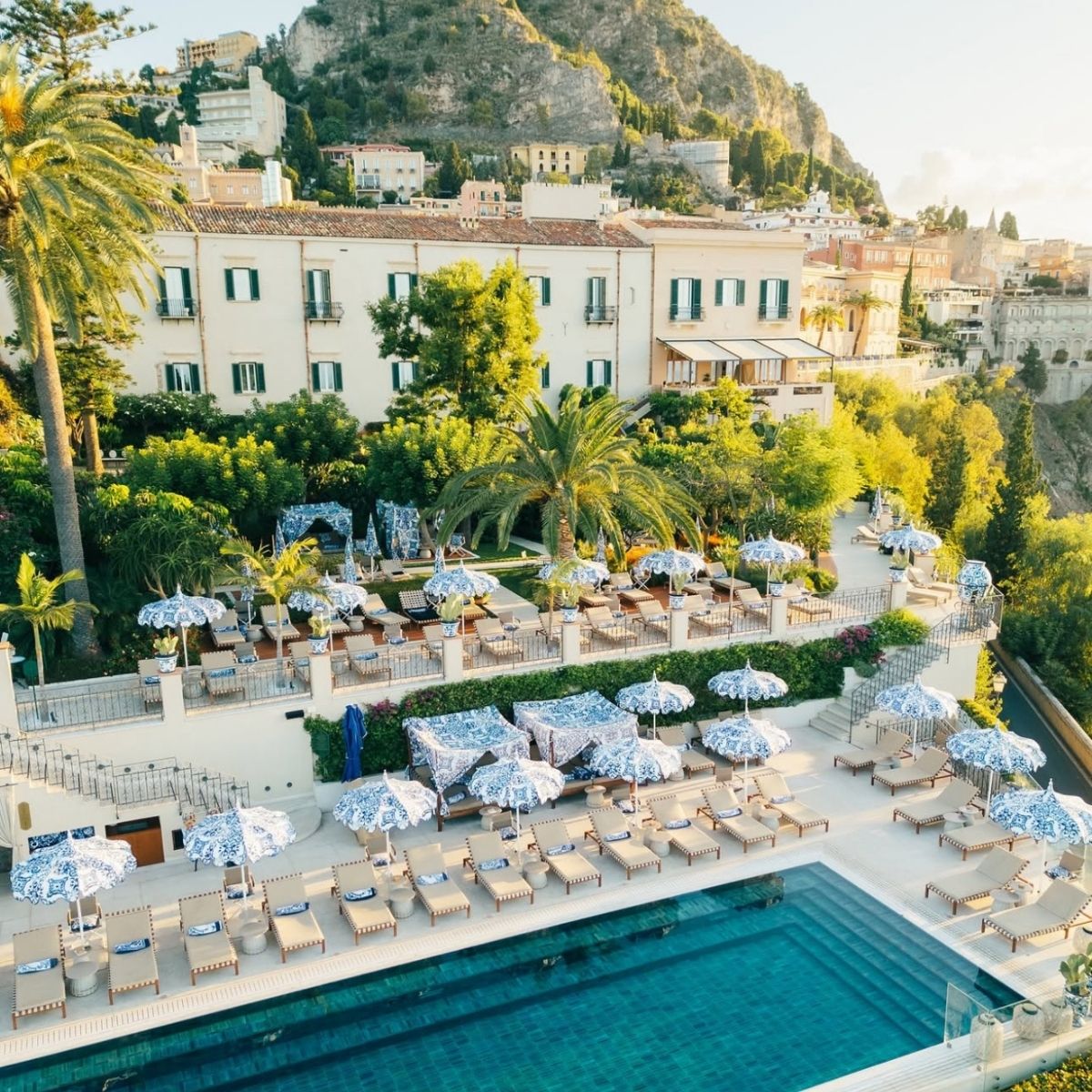 villa with green shutters on the taormina cliffside with infinity pool