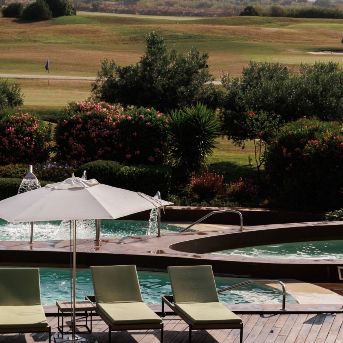 pool set on a green golf course with trees