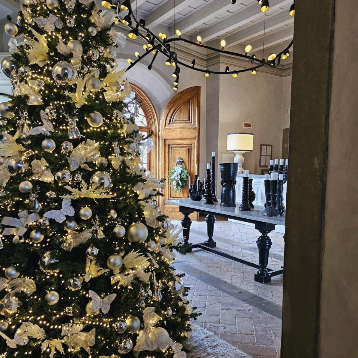 christmas tree with gold ornaments and silver butterflies