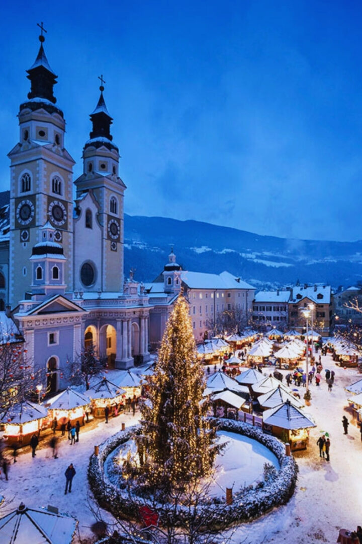italy old town covered in snow with christmas tree in the square