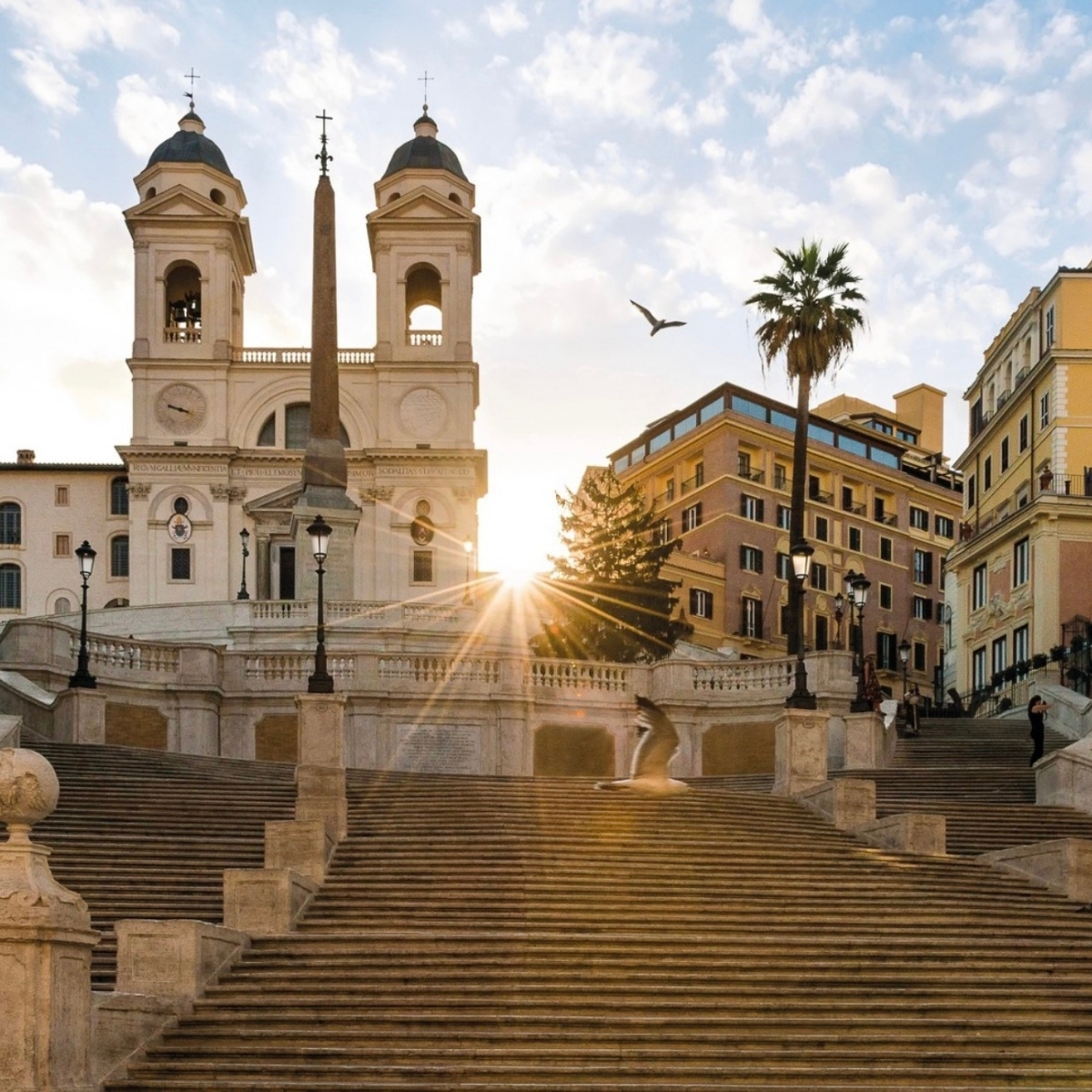 Elegant view of the Spanish Steps leading up to Hotel Hassler in Rome at sunset
