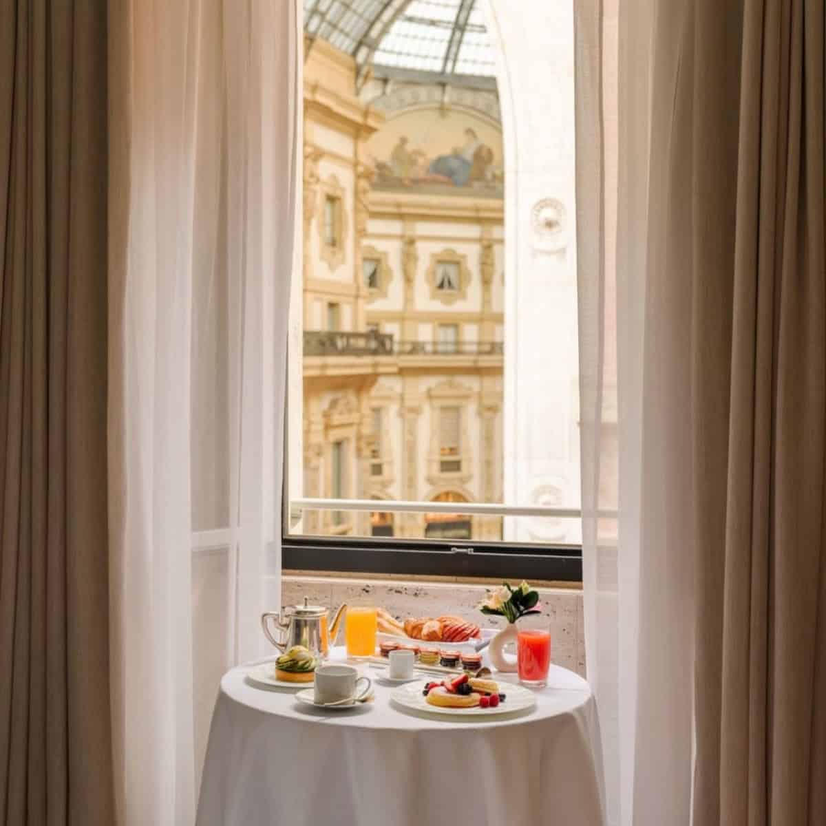 Breakfast setup by a large window at Park Hyatt Milano