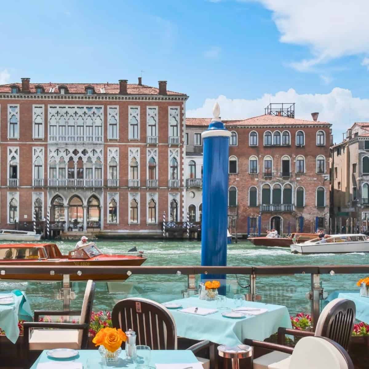 Beautiful view of a canal in Venice with boats and historic architecture at The Gritti Palace Venice