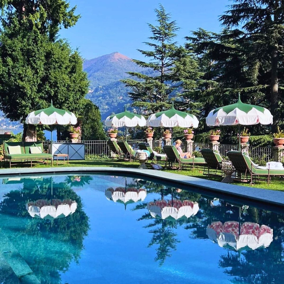 Sunlit pool at Passalacqua hotel overlooking Lake Como, Italy