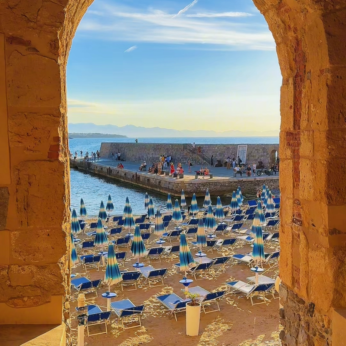 Porta Pescara — the ancient medieval fishermen's gate in Cefalù framing the Tyrrhenian Sea