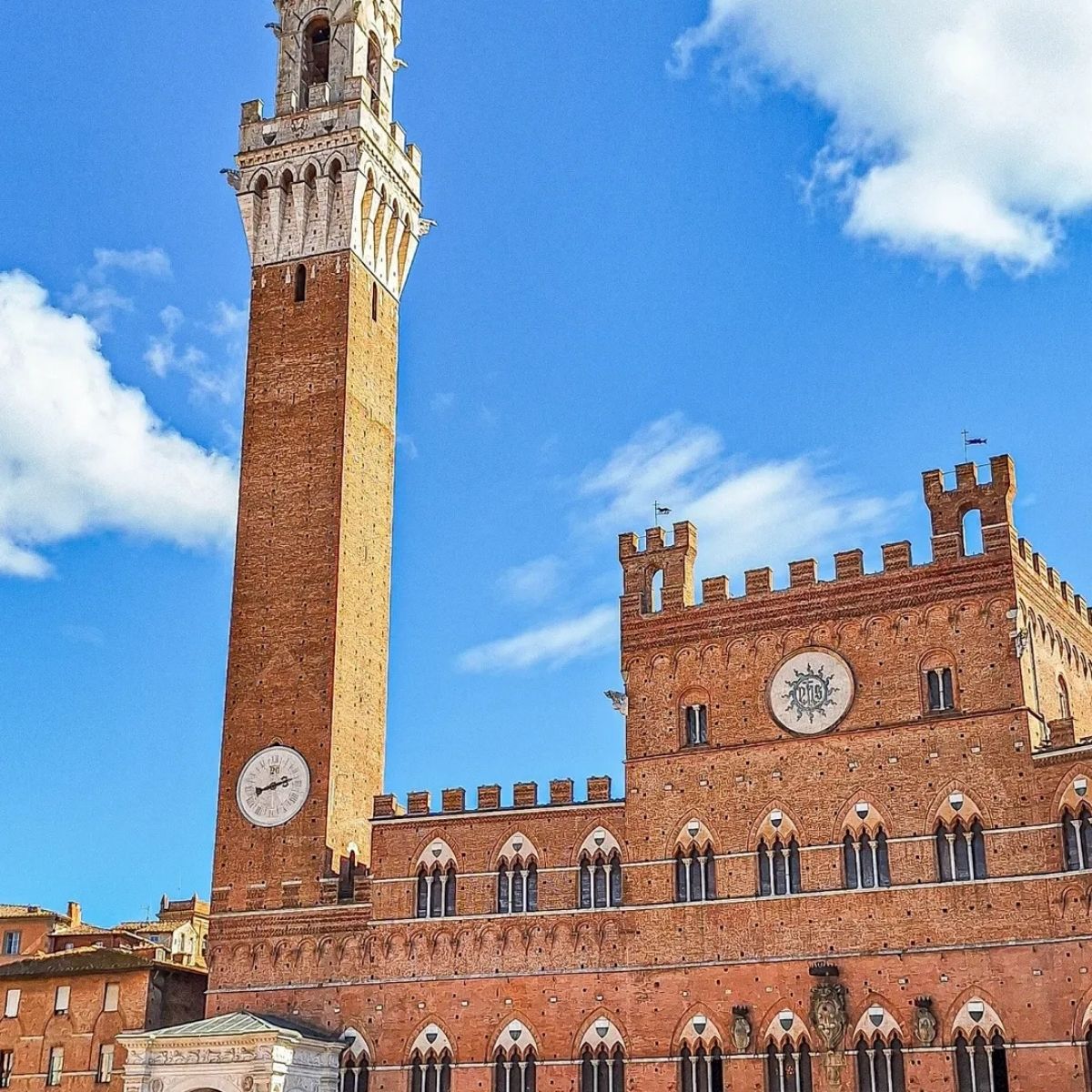 Rolling Tuscan countryside with hilltop Siena in the distance