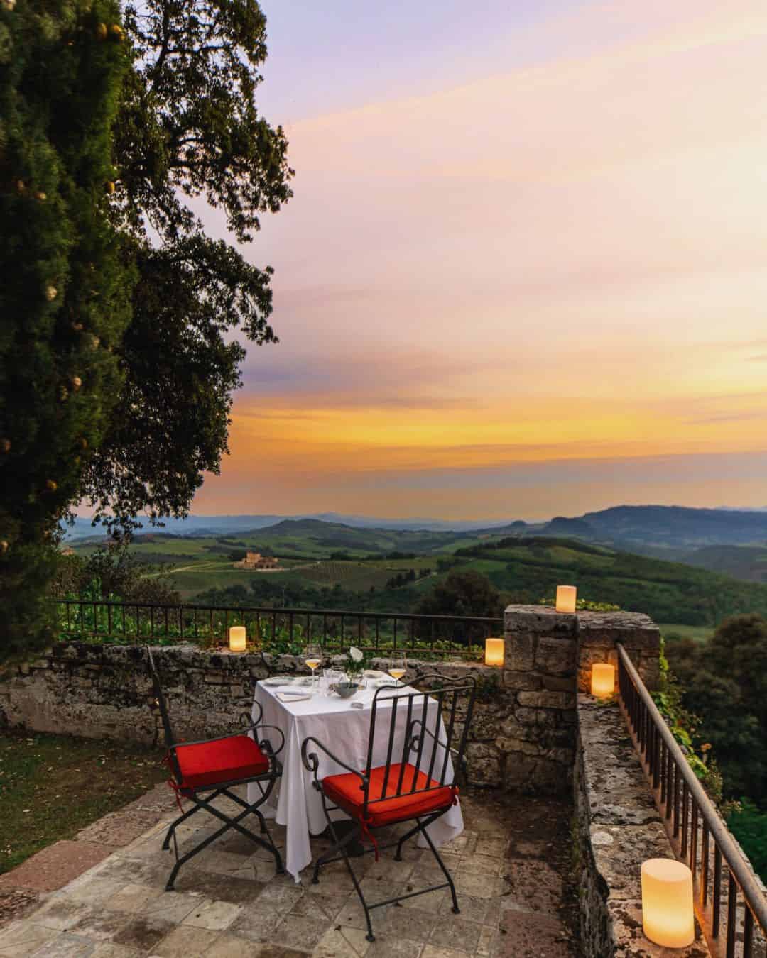 Romantic outdoor table at Borgo Pignano 18th-century Tuscan hamlet hotel near Volterra surrounded by fall olive groves