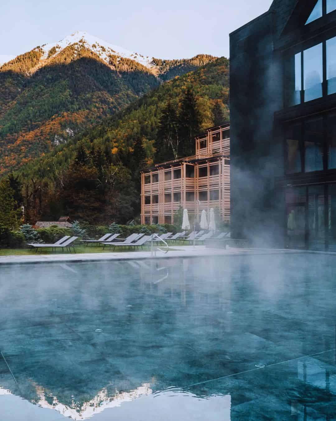Lefay Resort and Spa Dolomiti Pinzolo Trentino with golden larch forest in fall