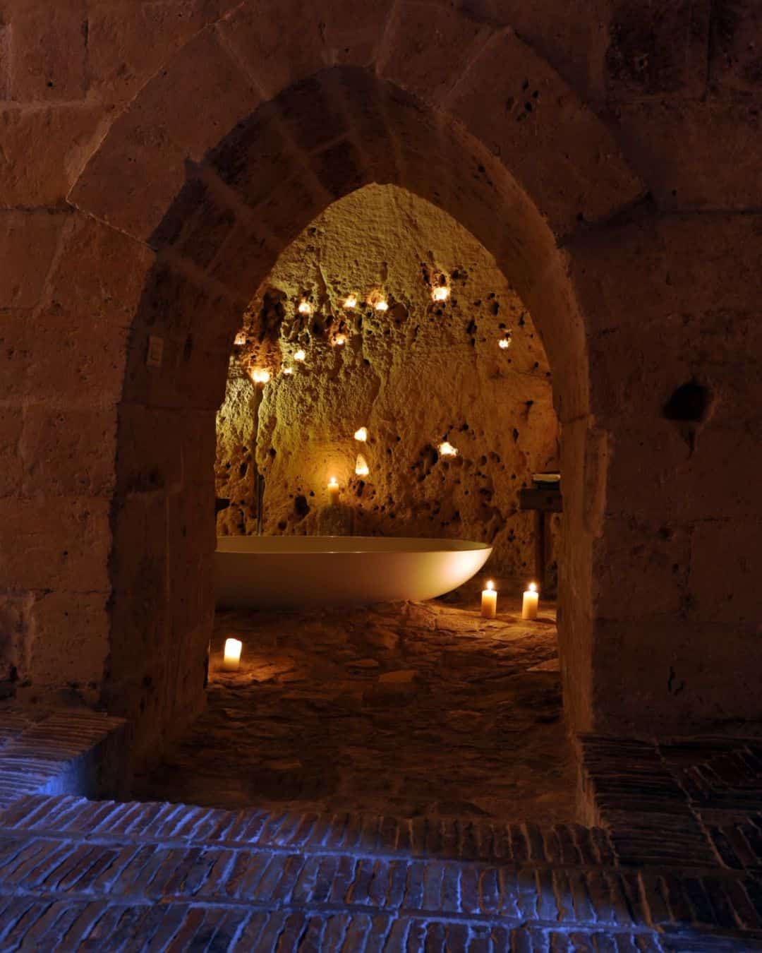 Sextantio cave hotel carved into the ancient Sassi di Matera glowing in fall light